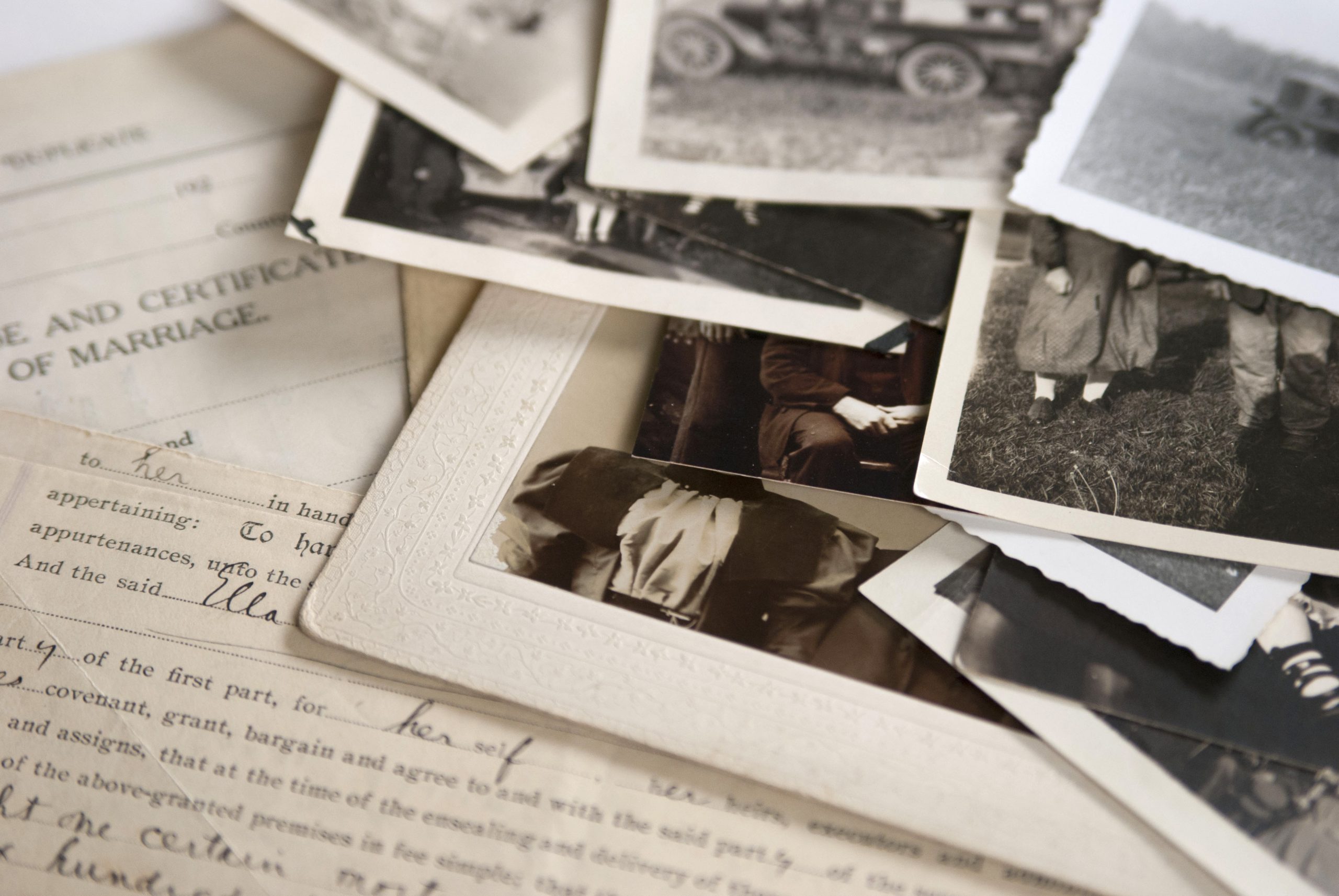 Pile of black and white photos and documents for a biography or autobiography