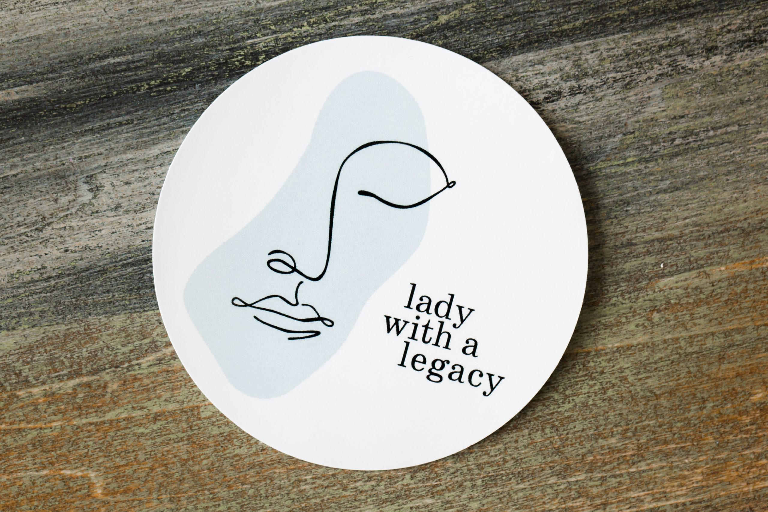 Round sticker with Lady with a Legacy on it